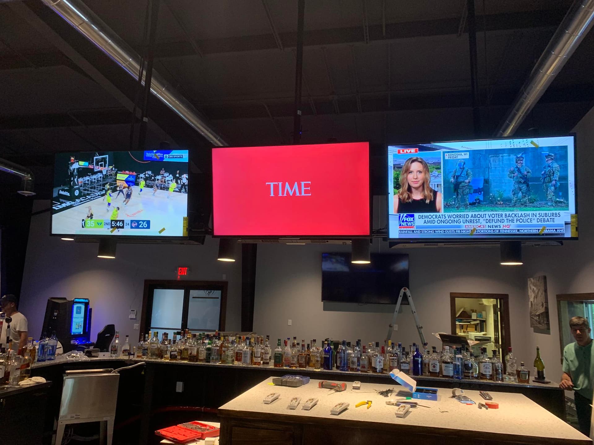 Multiple TVs installed above a sports bar