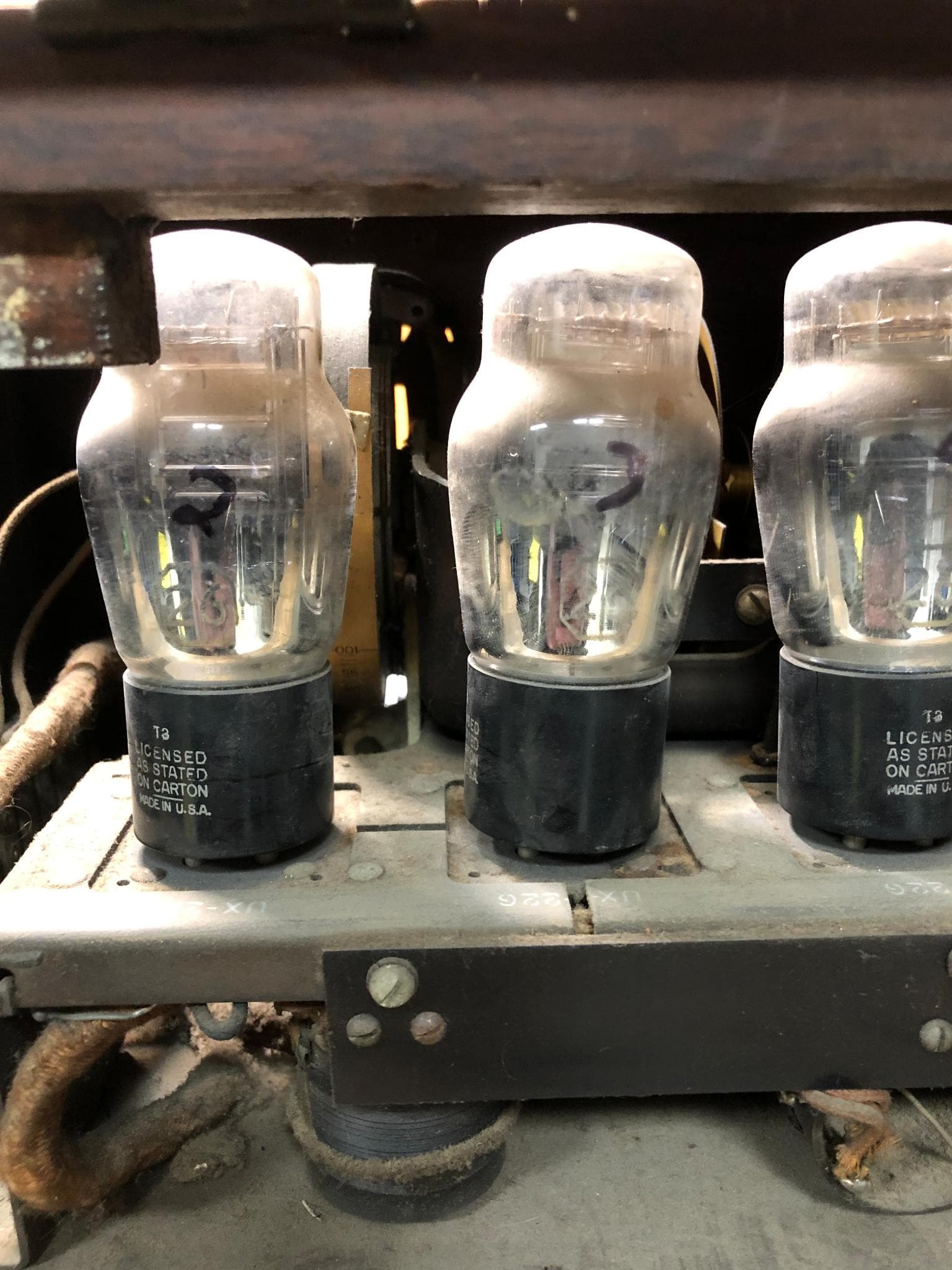 Vintage vacuum tubes in antique equipment being repaired